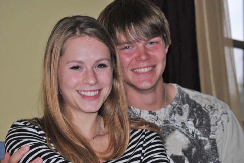 Warm close-up of Ashton beaming beside his girlfriend