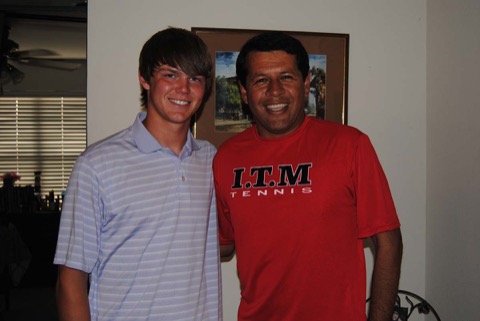 Ashton arm-in-arm with Coach Moralez in his red I.T.M TENNIS shirt, both laughing